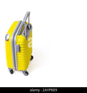 Modern yellow suitcase isolated on white. Travel baggage and tourism concept Stock Photo