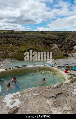 People are bathing in a pool fed by hot springs at Hveravellir, a geothermal area of fumaroles, and multicolored hot pools in the central highlands of Stock Photo