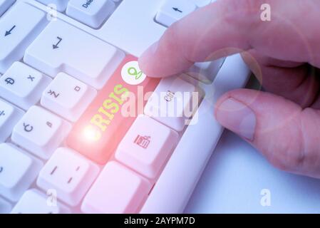 Writing note showing Crisis. Business concept for time when difficult or important decision must be made danger Stock Photo