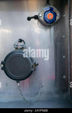 Nozzle for loading and unloading a tanker truck of dangerous goods with a single compartment, connection for overfill probe and grounding. Stock Photo