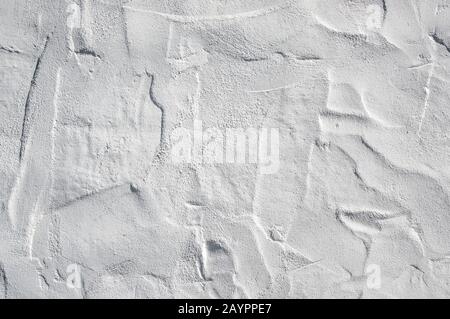 Close up on whitewashed rough wall surface. Uneven roughcast texture Stock Photo