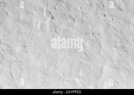 Close up on whitewashed rough wall surface. Uneven roughcast texture Stock Photo