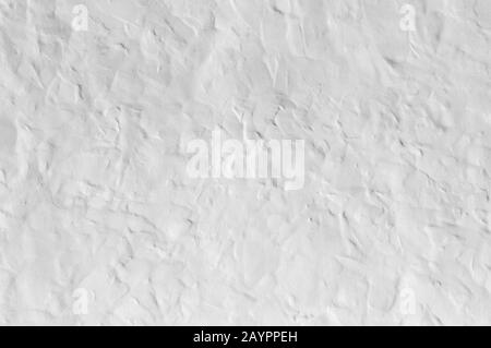 Close up on whitewashed rough wall surface. Uneven roughcast texture Stock Photo