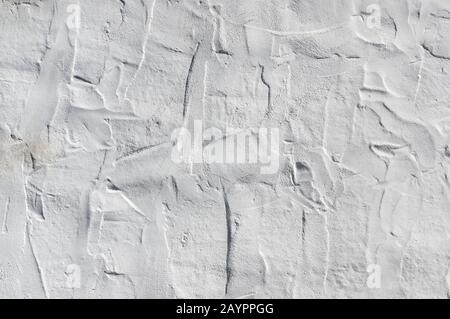 Close up on whitewashed rough wall surface. Uneven roughcast texture Stock Photo