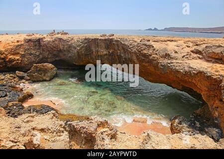 Natural Bridge, that was formed out of coral limestone, Aruba, Lesser Antilies, Caribbean. Stock Photo