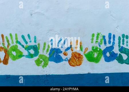 Detail of a house with colorful handprints on the wall on the tropical island of Isla Taboga off the coast of Panama City, Panama. Stock Photo