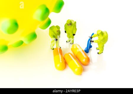 closeup of big corona virus with a team of special medical forces miniature figurines interfering during gas and other chemical accidents, the team pr Stock Photo