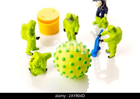 closeup of big corona virus with a team of special medical forces miniature figurines interfering during gas and other chemical accidents, the team pr Stock Photo