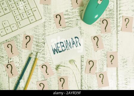 Conceptual hand writing showing Webinar. Concept meaning defined as seminar conducted over the Internet Web conferencing Writing tools and scribbled p Stock Photo