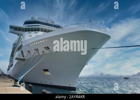 Huge White Cruise Ship Tied to Bollard on Pier Stock Photo
