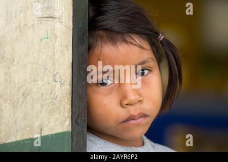 Portrait of a sad looking Kichwa native girl at the native community O El Pilchi near La Selva Lodge near Coca, Ecuador. Stock Photo