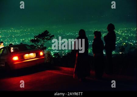 GUATEMALA - DECEMBER, 2019 City night in view on the top of the mountain. car and people Stock Photo