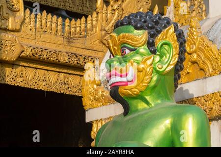 A green guardian figure at the southern stairway of the 2,500 years old Shwedagon Pagoda in Yangon (Rangoon), the largest city in Myanmar. Stock Photo