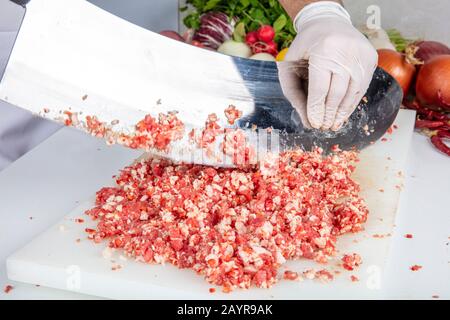 meat kebab restaurant chefs, making minced meat in Turkey. Meat mincing is called local minced meat ( satir kiyma ) or armor minced (zirh kiyma). Stock Photo