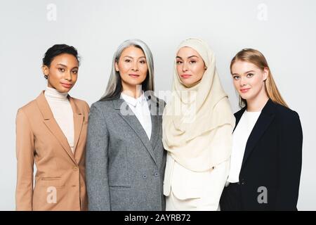 beautiful multicultural businesswomen looking at camera isolated on white Stock Photo
