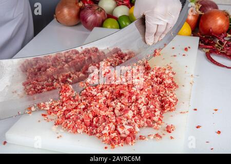 meat kebab restaurant chefs, making minced meat in Turkey. Meat mincing is called local minced meat ( satir kiyma ) or armor minced (zirh kiyma). Stock Photo