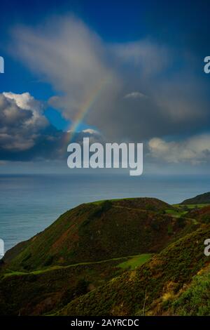 Rainbow Through Clouds Over Pacific Coast along Big Sur Stock Photo