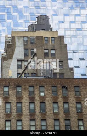 Old against the new. Looking up in midtown Manhattan, New York City. Stock Photo