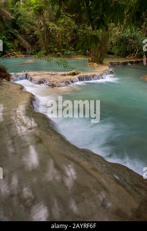 The lower cascades and turquoise blue pools of the Kuang Si Falls near Luang Prabang in Laos. Stock Photo