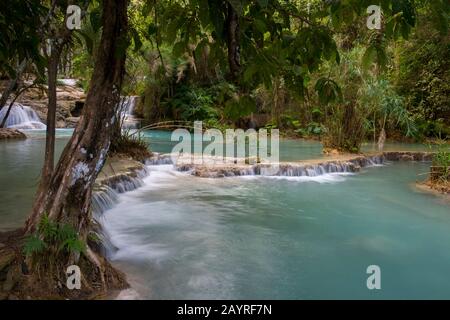 The lower cascades and turquoise blue pools of the Kuang Si Falls near Luang Prabang in Laos. Stock Photo