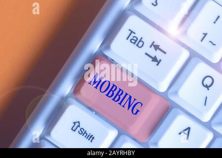 Writing note showing Mobbing. Business concept for Bulling of individual specially at work Emotional abuse Stress Stock Photo