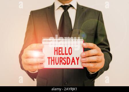 Text sign showing Hello Thursday. Business photo showcasing the greeting used to welcome the day after wednesday Male human wear formal work suit offi Stock Photo