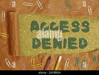 Writing note showing Access Denied. Business concept for error message shown when you do not have access rights Stationary and torn cardboard on a woo Stock Photo