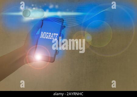Writing note showing Migrate. Business concept for to move or travel from one country place or locality to another Stock Photo