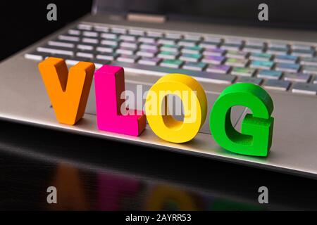 Vlog or video blog concept with vlog word from funny letters on the background computer keyboard Stock Photo