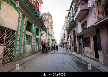 November 28, 2019, Havana, Cuba: View of authentic street with old colonial buildings and local people at every day life. old part of Havana City. Stock Photo