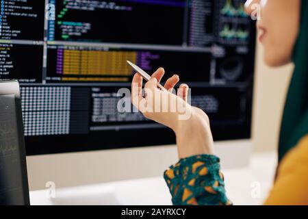 Cropped image of muslim female IT student working on programming code for university project Stock Photo