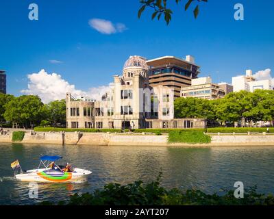 The Hiroshima Peace Memorial (Genbaku Dome, Atomic Bomb Dome or A-Bomb Dome). Also a Gangi Water Taxi on the Ota River in Hiroshima, Japan. Stock Photo