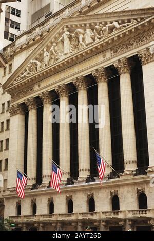 Classic Wall Street Stock Exchange building view with three American Flags out front Stock Photo