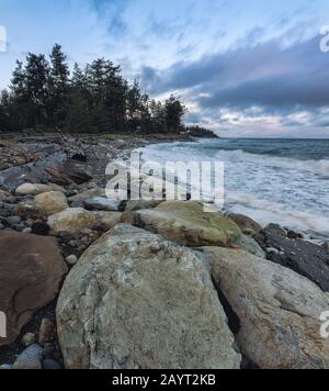 Windy morning with waves on rocky Kin Beach Provincial Park. Stock Photo