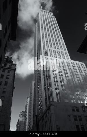 Empire State Building ,a dramatic low angle view of the Art Deco skyscraper located in Midtown Manhattan, New York in black and white Stock Photo