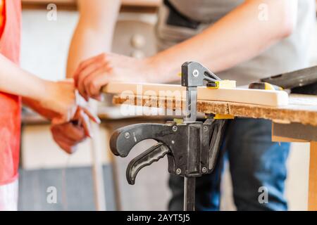 carpenter working with wood, close up on hands Stock Photo