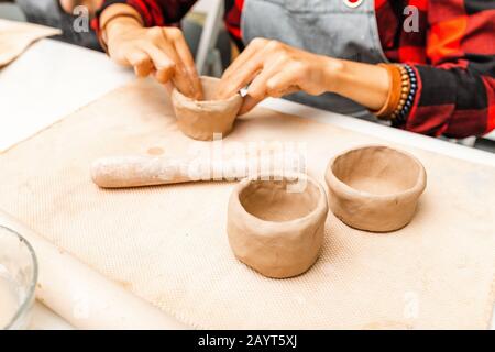 Young woman friends create clay and ceramic art dishes in pottery workshop Stock Photo