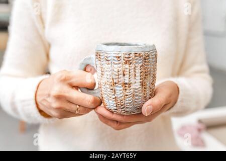 Tea cup in female hands Stock Photo