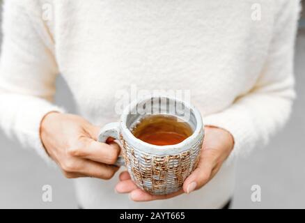 Tea cup in female hands Stock Photo
