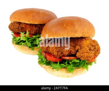 Southern fried chicken sandwiches with salad in brioche bread rolls isolated on a white background Stock Photo