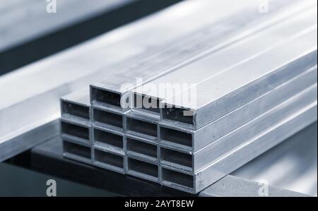 Aluminum profile with rectangle section, industrial background photo, blue toned Stock Photo