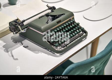 Antique typewriter with sheet on light table indoors Stock Photo
