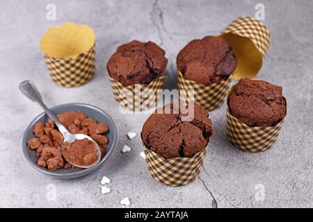 Chocolate muffins with edible eyes in paper holders Stock Photo - Alamy