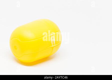 a yellow closed toy egg on white background Stock Photo