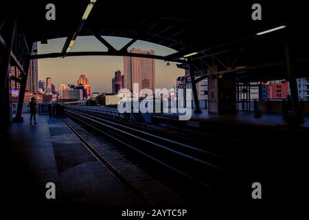 Cinematic cityscape of Bangkok City showing the railway track leading to the city center during dusk Stock Photo