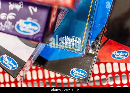 Feb 10, 2020 Sunnyvale / CA / USA - Hasbro Gaming logos visible on several Game boxes stacked in a shopping cart; Hasbro Inc is an American worldwide Stock Photo