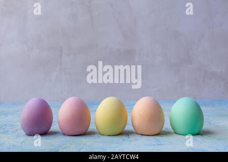 Row of easter eggs painted in plain colors with copy space Stock Photo