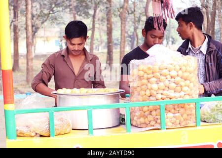 Fusca Chotpoti is Popular street food cart and salesman of Bangladesh and India. this food Looks like chips.a roadside shop Indian bengali food dish a Stock Photo