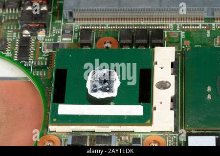 Close up of  laptop processor with thermal paste on main board of notebook. Stock Photo
