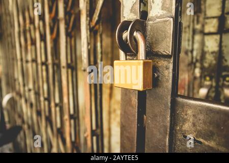 Locked padlock outside of the store old building, for security or safety concept. Stock Photo